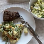 Steak, warm potato salad, salad