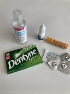 Gum, migraine medication, hand sanitizer, contact rewetting drops & lip balm